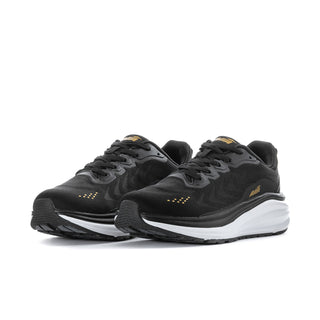 Pair of women’s black wide sneakers with white midsoles and pale gold accents