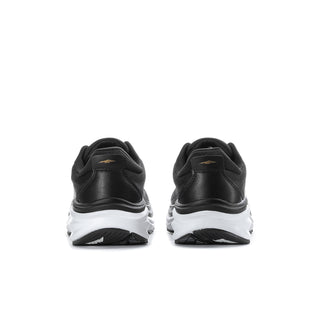 Women’s black wide sneakers rear view with white midsole and pale gold logo