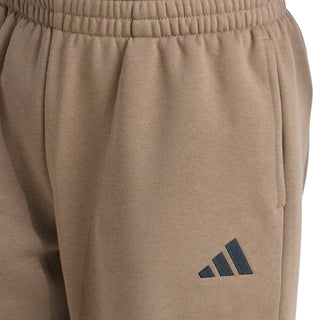 Khaki youth fleece jogger pants close-up: elastic waistband and adidas logo