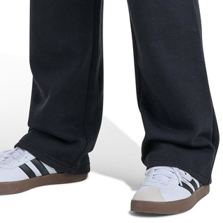 Youth black fleece jogger pants with cuffed hem and white slide-on sneakers