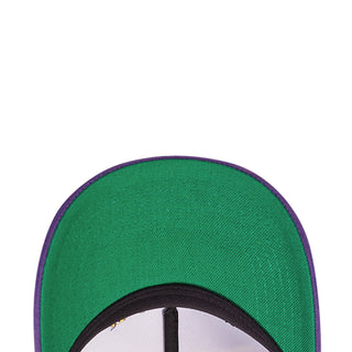 Green cap interior close-up with purple trim and black ring at the opening