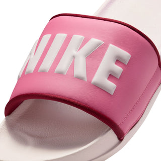 Close-up of women's slide sandal strap in magenta with large white NIKE letters