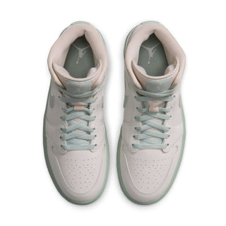 Pair of women's mid-top sneakers showing padded tongue and lace-up front