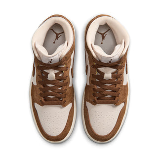 Pair of women's mid-top sneakers with lace eyelets and Air Jordan tongue logo