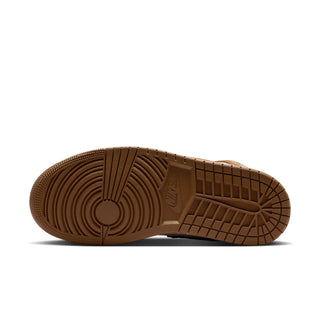 Brown rubber outsole with circular tread pattern on women's mid-top sneakers