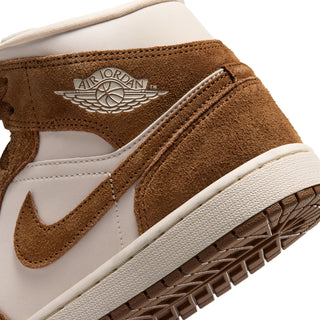 Close-up of women's mid-top sneakers with Air Jordan wing logo and textured outsole edge