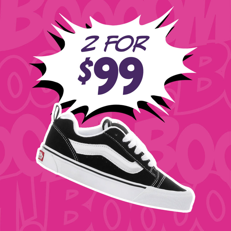 A black and white Vans platform sneaker shown against a bright pink patterned background with a white comic-style burst reading '2 FOR $99'.