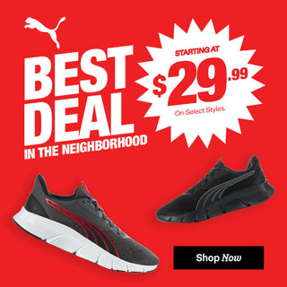 Promotional advertisement for Puma shoes with a red background, featuring text and two black sneakers.