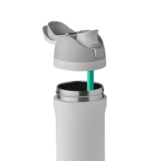 FreeSip 24 oz stainless steel bottle with teal straw and open lid for drinking.
