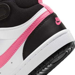Kids sneaker side close-up, pink stitched swoosh stripe and white midsole