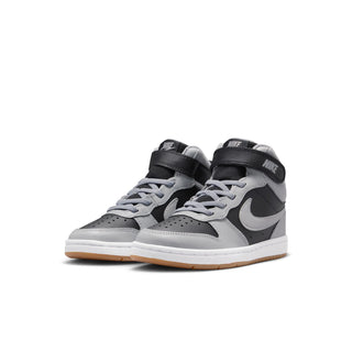 Kids pair of mid-top sneakers in light gray with black accents, white Swoosh, gum sole.