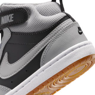 Kids sneaker upper detail: light gray mesh and leather with black trim, stitched seams.