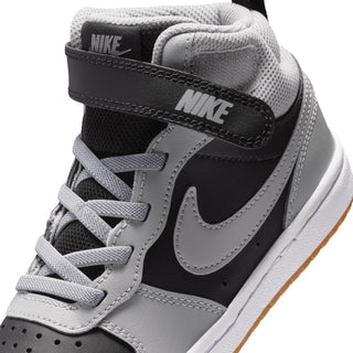Kids sneaker collar and side detail with black heel strap, light gray laces, Nike branding.