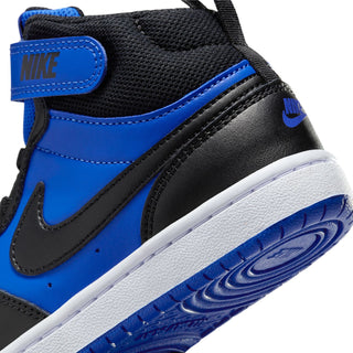 Kids sneaker close-up: royal blue and black upper with stitched swoosh and white sole