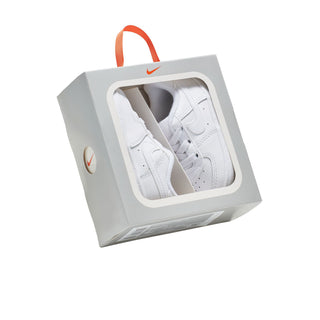 Infant white low-top sneakers in retail box, swoosh logo visible on box