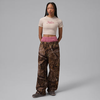 Women wearing dark brown retro sneakers with patterned pants and lace-up front