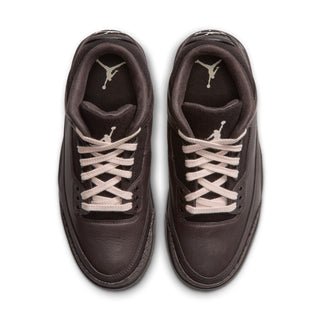 Pair of women's retro sneakers with dark uppers, off-white laces, and woven tongue lining