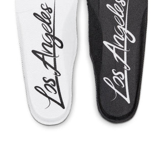 Men's Nike low-top sneaker insoles close-up with 'Air' script on white and black lining.