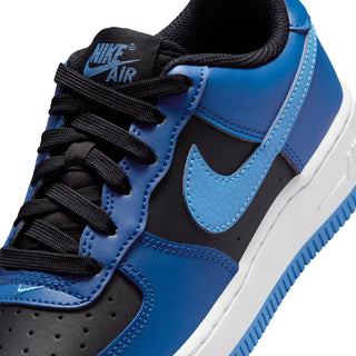 Youth Nike Air sneaker close-up, blue panels with black laces and swoosh