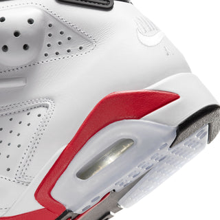 Men's white sneaker side close-up with red panel and visible Air unit window