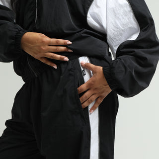 Women’s wind pants close-up: elastic waistband and white side panel