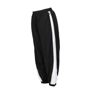 Women’s wind pants side view in black with vertical white stripe
