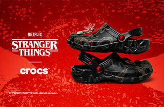 Black Crocs shoes on a red background with Netflix Stranger Things logo
