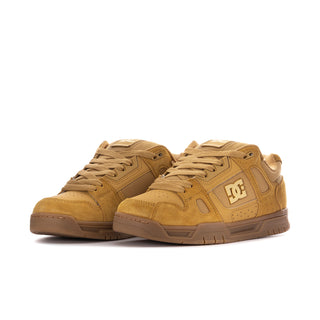 Men's tan low-top sneakers, front view with lace-up panels and DC logo