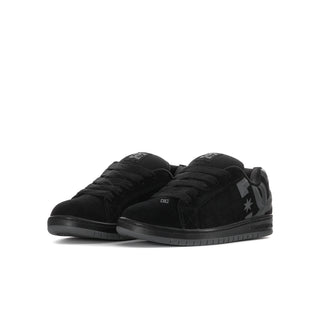 Youth black lace-up sneakers with large DC logo panel and star mark, low profile.