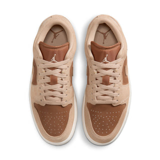 Pair of light tan low-top sneakers with lace-up closure and perforated toe
