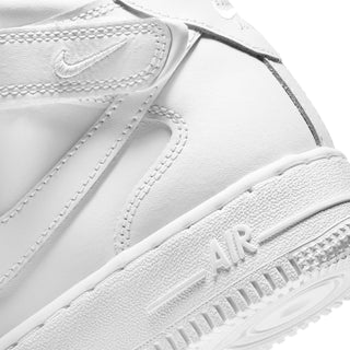 White youth mid-top sneakers, close-up of side panel stitching and swoosh