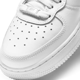 White youth mid-top sneakers, close-up of perforated toe box and stitching
