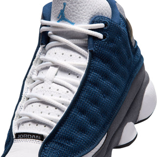 Youth retro basketball shoe close-up, white laces on navy knit with gray heel and Jumpman logo