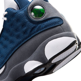 Youth retro basketball shoe close-up, green eyelet on gray heel with navy knit side panel