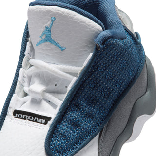 Toddler sneaker close-up: white tongue, blue Jumpman logo, knit navy heel