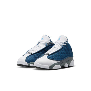 Kids sneakers with white uppers, blue textured panels, gray midsole, lace-up