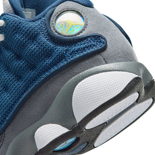 Kids sneaker close-up of blue upper, heel emblem, and gray midsole