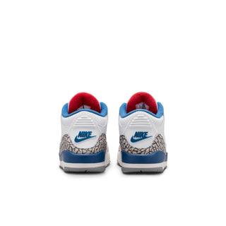 Kids sneakers heel view with red lining, blue Nike logo, and cement grey textured panel.