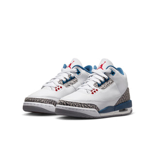 Youth white leather sneakers, side view, blue midsole, elephant-print panel, and red eyelets