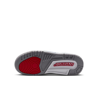 Youth sneaker outsole with gray tread and a red circular traction section