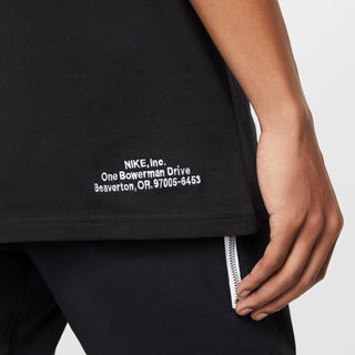 Black Nike t-shirt hem label text: “NIKE, Inc… Beaverton, OR”
