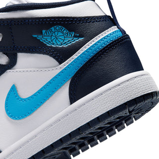Kids sneaker close-up of navy collar tag, light blue stripe, and white outsole