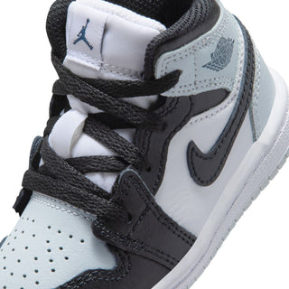 Toddler shoe upper close-up with black laces, white panels, and gray wing logo