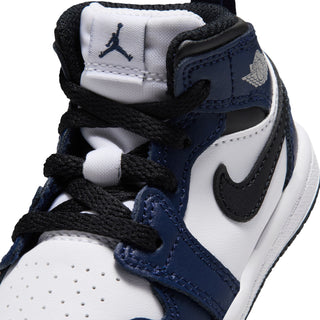 Toddler sneaker close-up with black laces, navy strap, and Jordan logo
