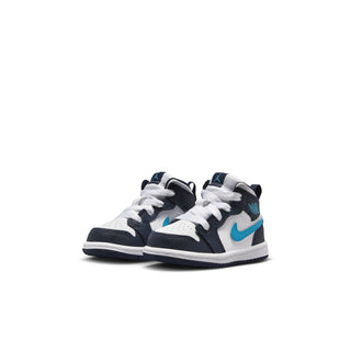 Toddler mid-top sneaker pair, white uppers with dark navy panels and light blue Nike swoosh