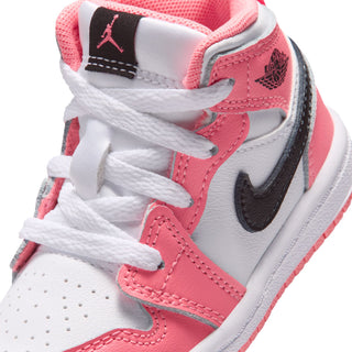 Toddler sneaker close-up: pink-and-white panels, black Swoosh, lace detail