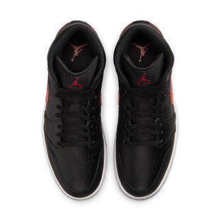 Black mid-top sneakers with red accents and perforated toe, lace-up front