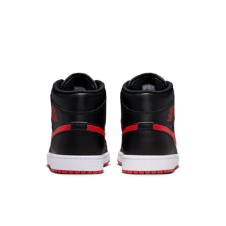 Black mid-top sneakers from the heel view with red stripe and white sole
