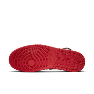 Red outsole tread of black mid-top sneakers