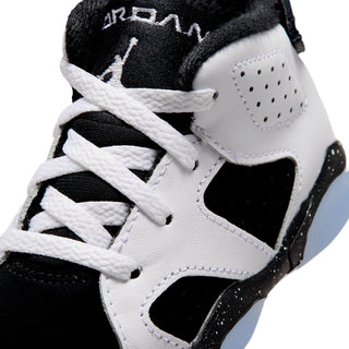 Toddler high-top sneaker close-up, white leather with perforated panel and black accent.